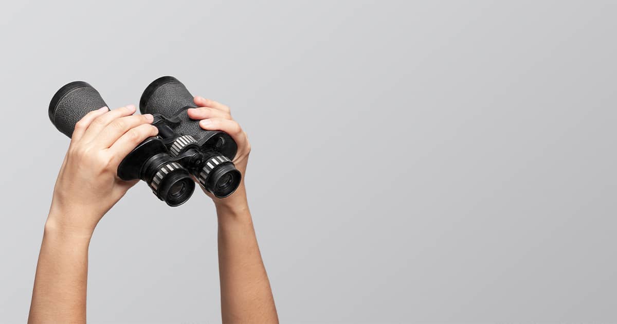 Hands holding binoculars